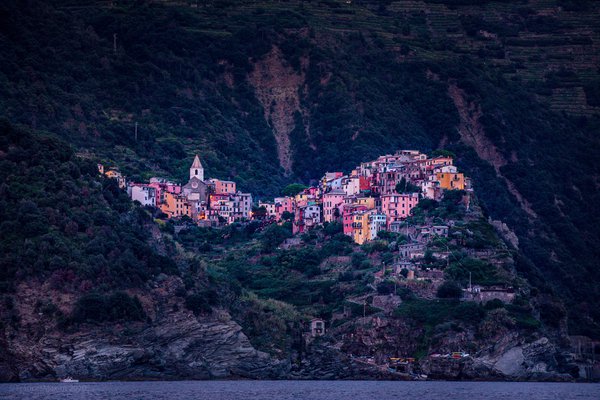 A Cinque Terre village stacked above the sea at twilight